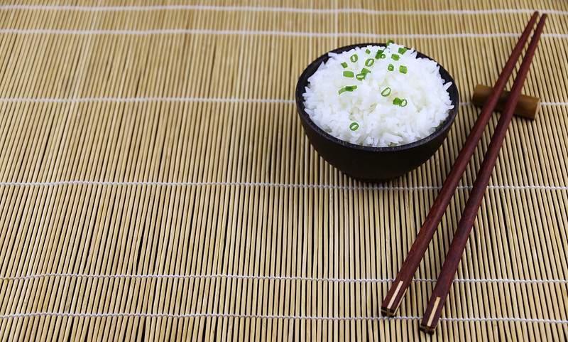 Chopsticks with rice in bowl